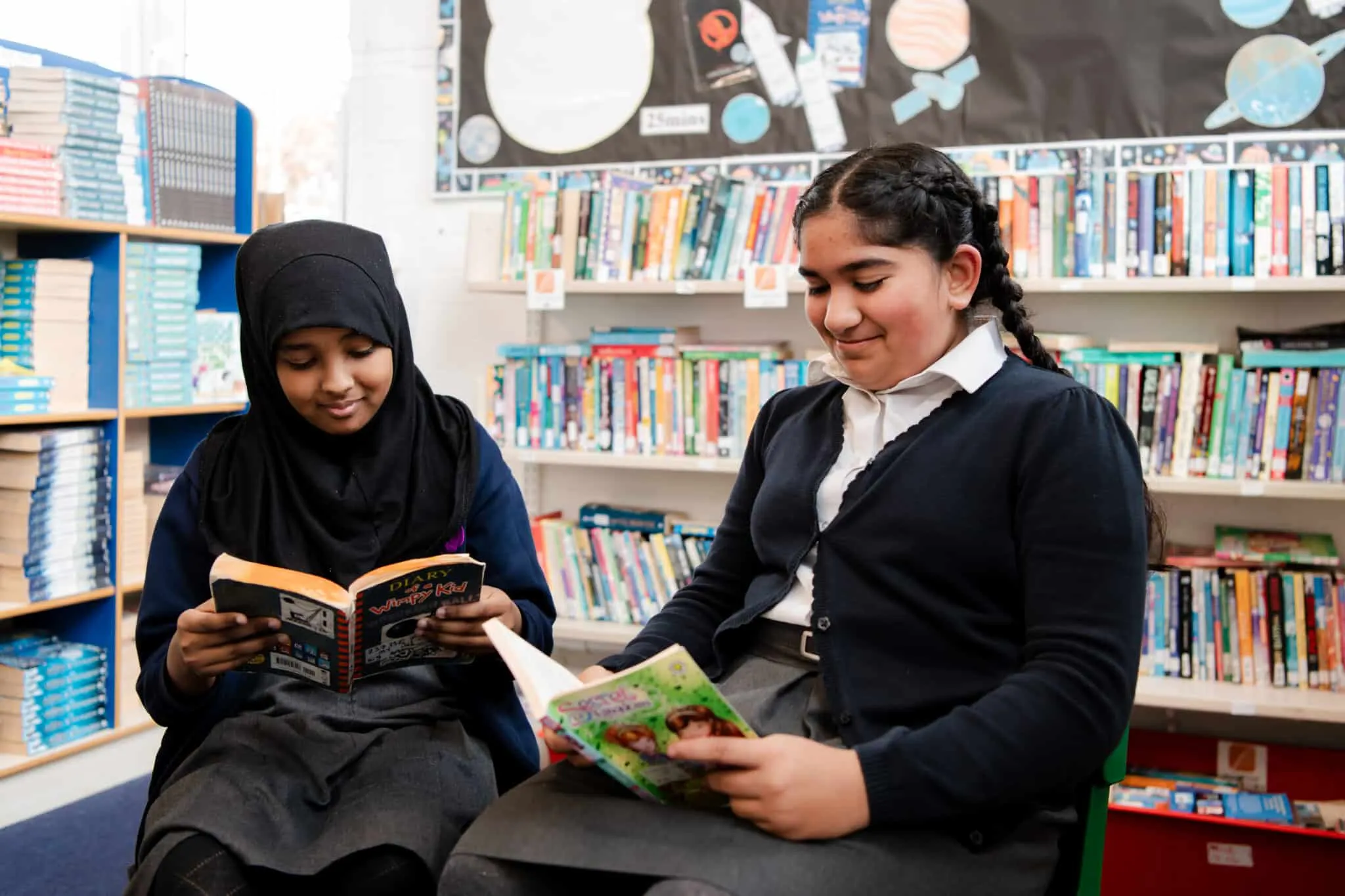 Two girls reading