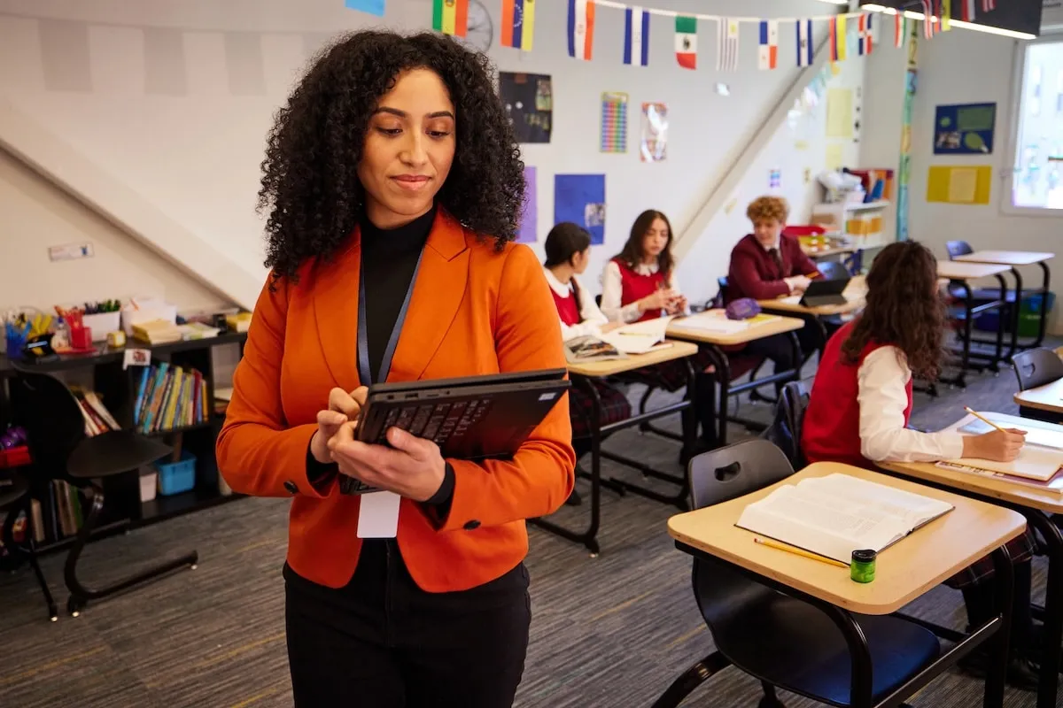 Teacher in classroom with tablet